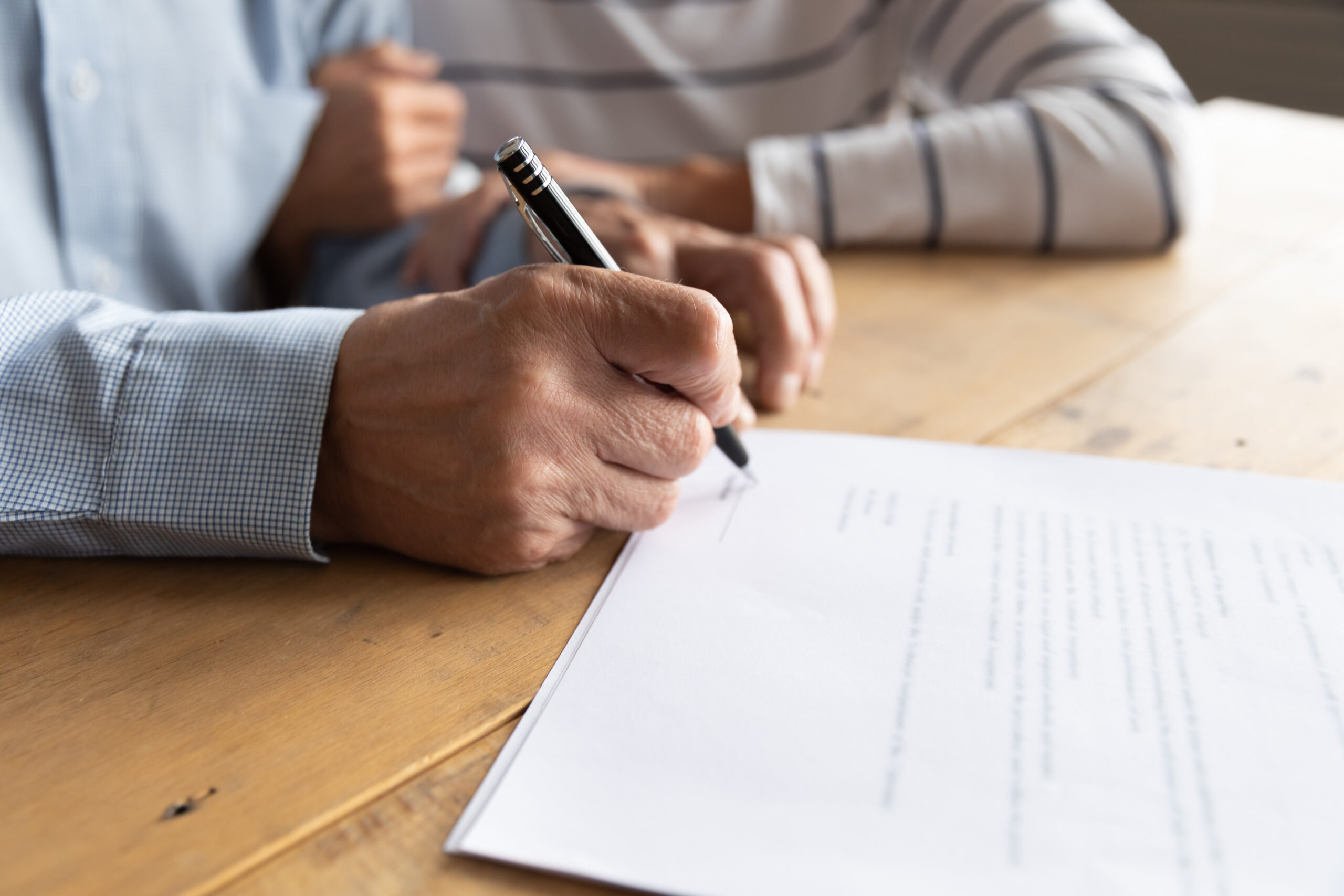 Close,Up,Elderly,Senior,Family,Couple,Signing,Contract,With,Real